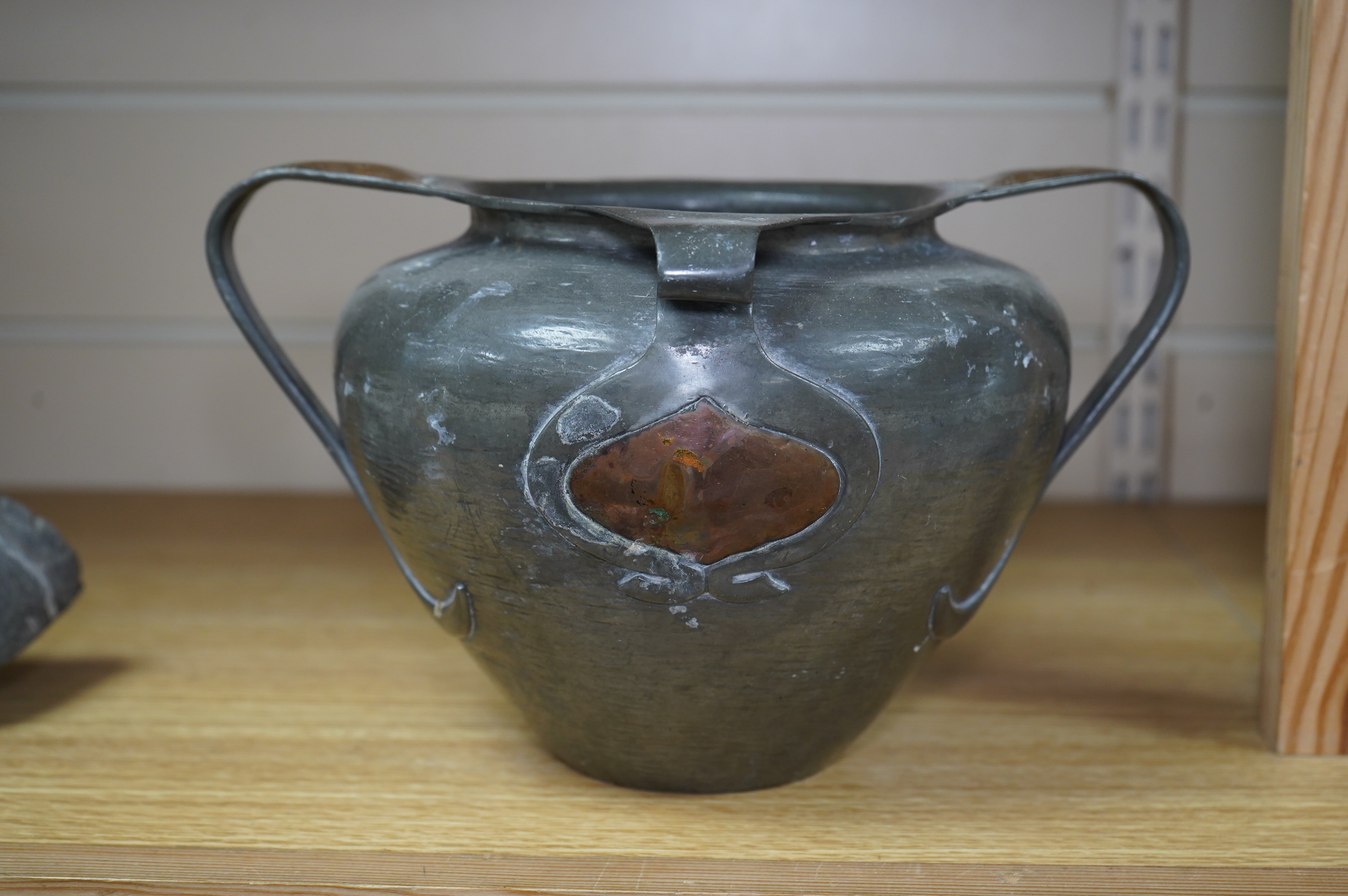 Oliver Baker for Liberty & Co, a Tudric pewter and copper vase, no.0864, c.1910, 25cm wide. Condition - fair to good